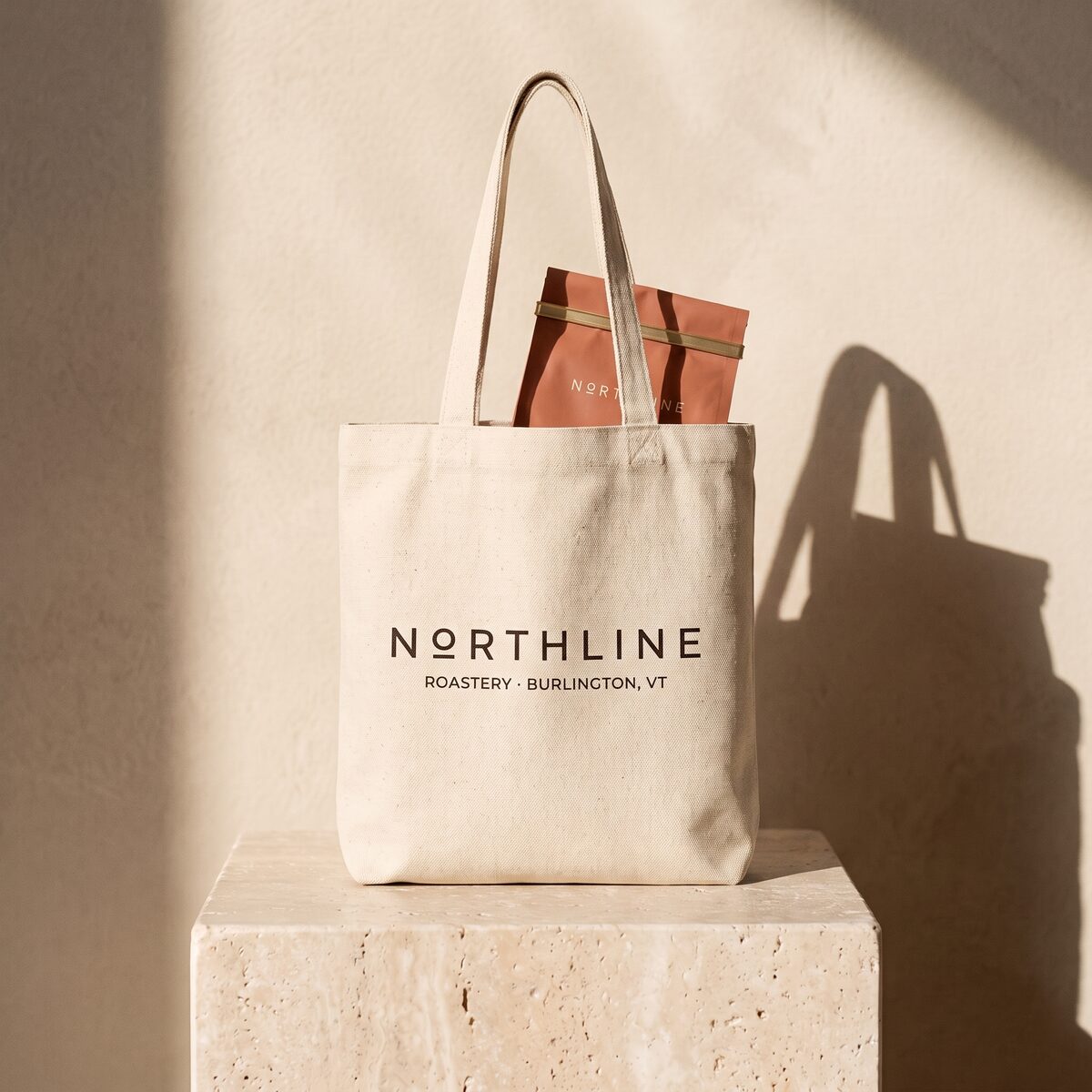 A natural canvas Northline roastery tote with a terracotta coffee bag peeking out of the top